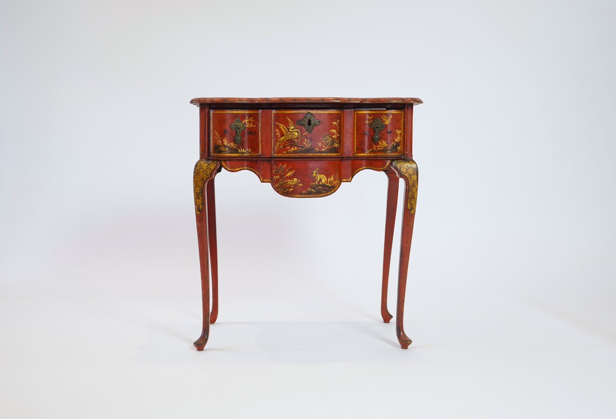 An early 18th century scarlet japanned lowboy